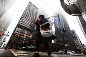 People cross Bay St. in Toronto's Financial District on Tuesday, January 6, 2026.  (Cole Burston/The Globe and Mail)